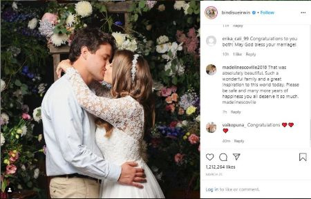   Bindi Irwin und Chandler Powell in ihrem Hochzeitskleid küssen sich als Hochzeitsritual
