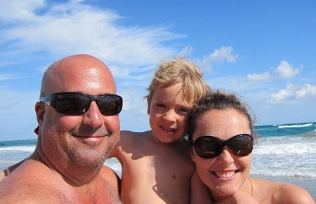   Andrew Zimmern and Rishia Haas with their son.